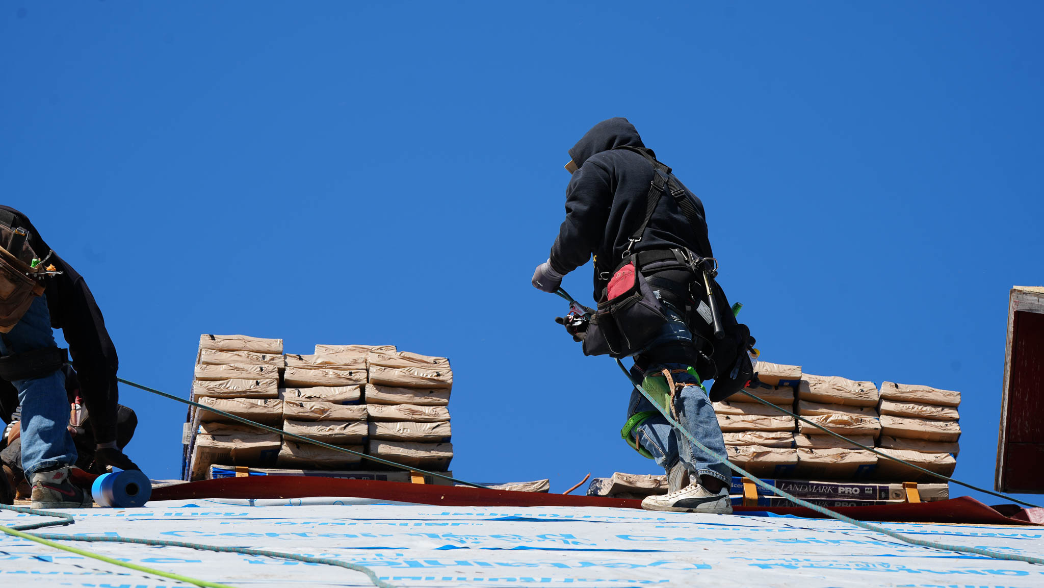 Roof installers on a roof installing CertainTeed Shingles