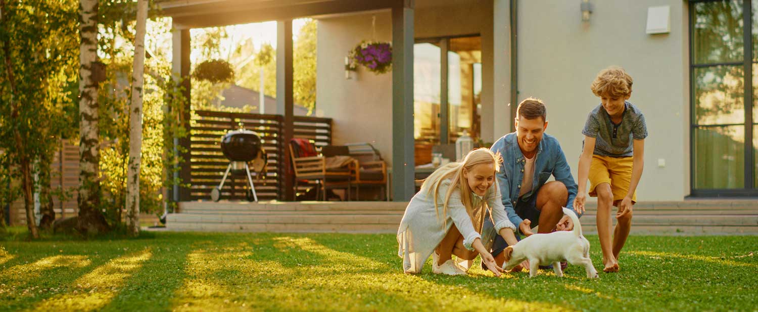 Family Playing in the yard of their home. Getting ready for that end of year roof check.